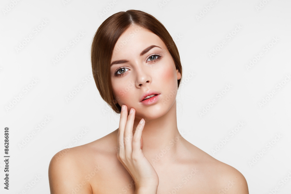 Young beautiful brunette woman with natural makeup on grey backg Young beautiful brunette woman with natural makeup on grey backg