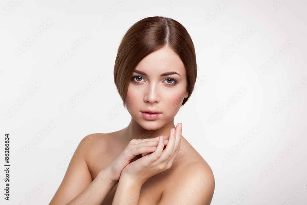 Young beautiful brunette woman with natural makeup on grey backg Young beautiful brunette woman with natural makeup on grey backg