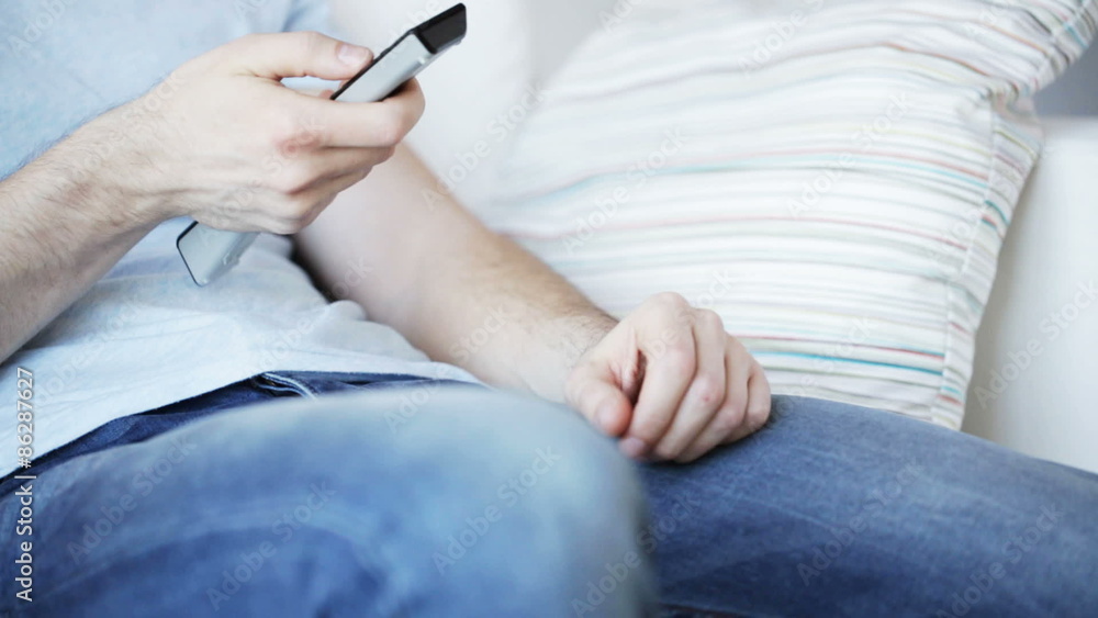 close up of man with beer and remote at home close up of man with beer and remote at home