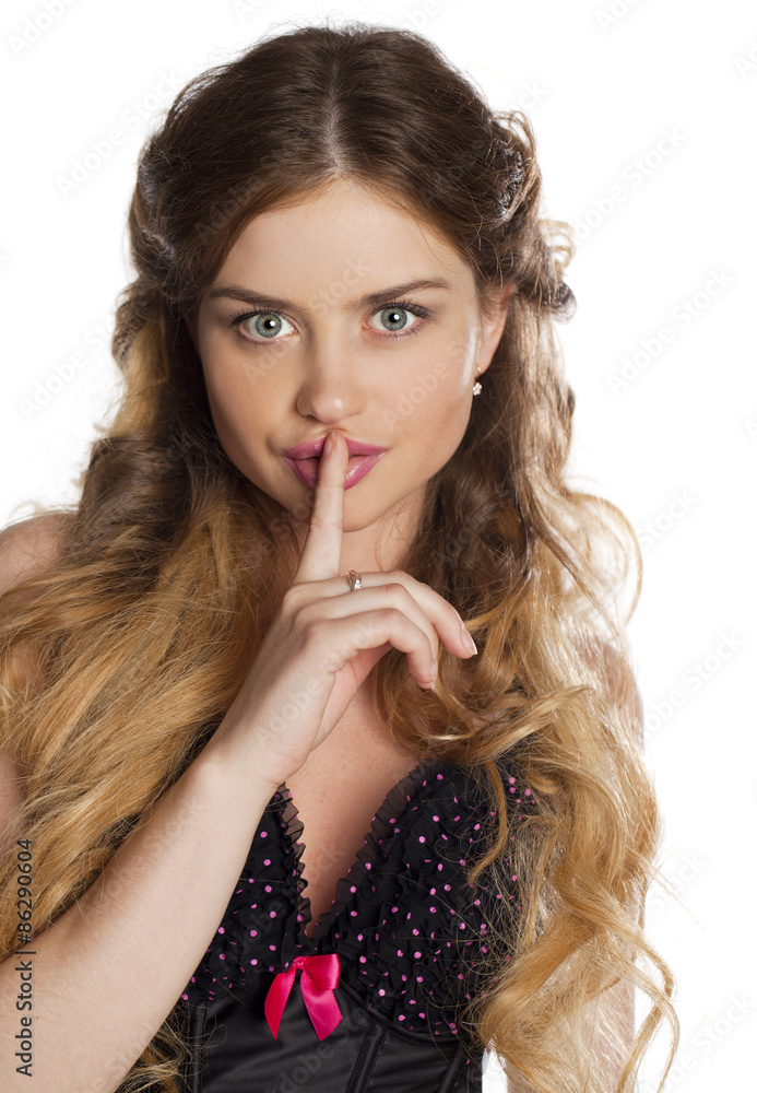 Portrait of attractive young woman with finger on lips Portrait of attractive young woman with finger on lips
