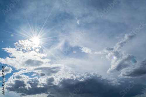 Sun rays against a blue sky in the clouds