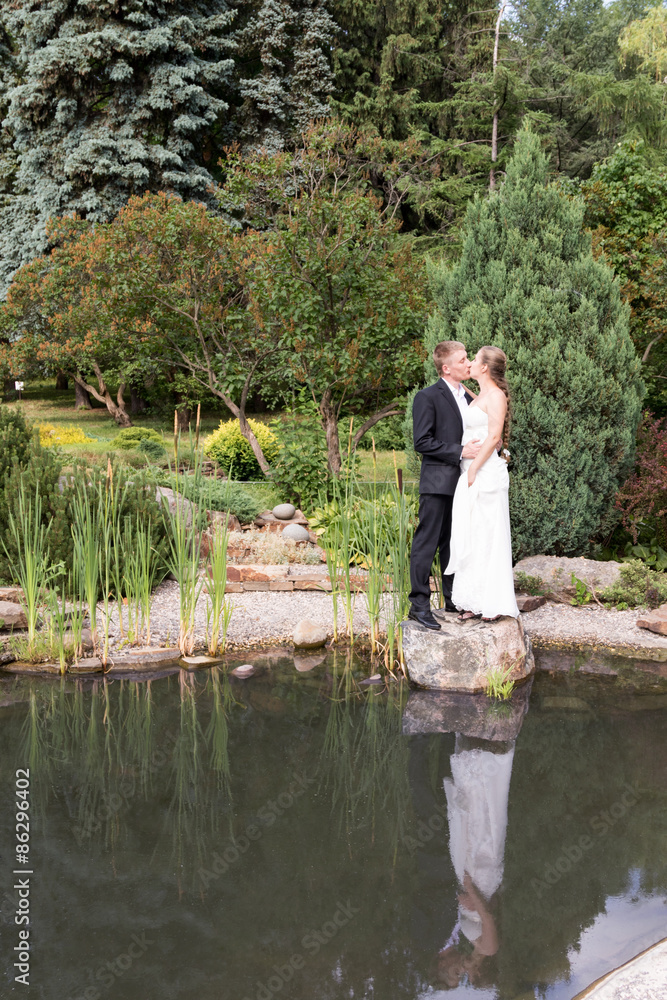 Bride and groom standing at the water Bride and groom standing at the water