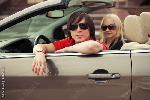 Happy young couple driving convertible car © Wrangler