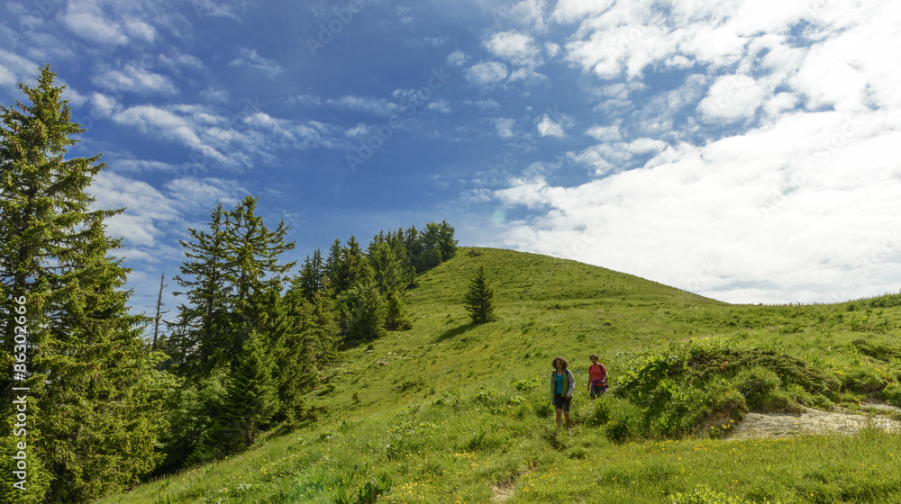 Two hikers women walking in the mountains