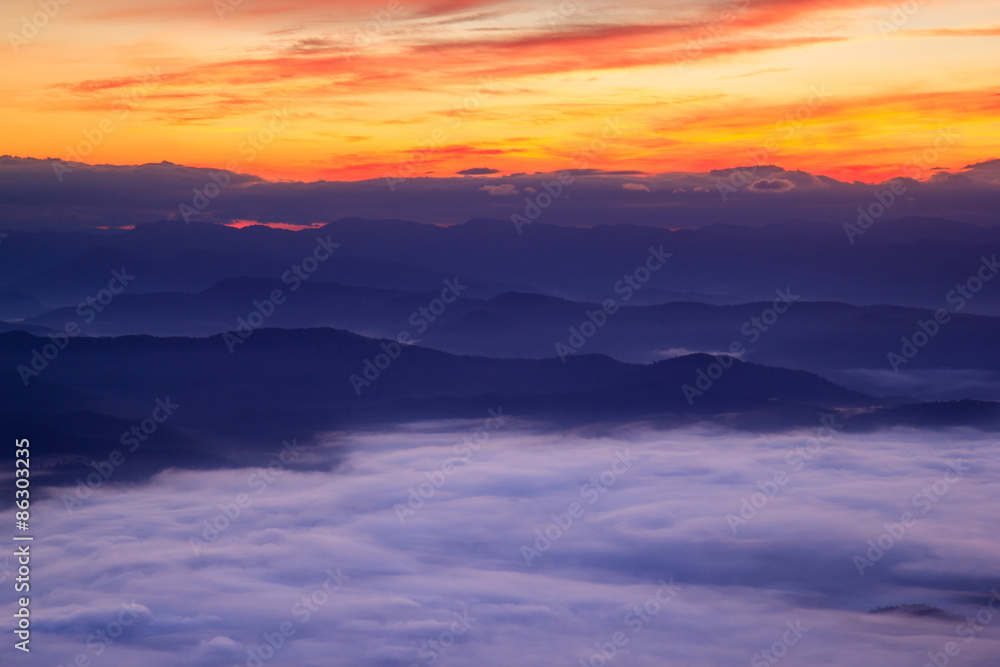 Layer of mountains in the mist at sunrise time
