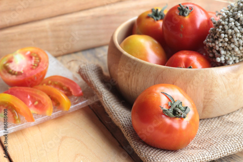 Fresh tomato on wood background