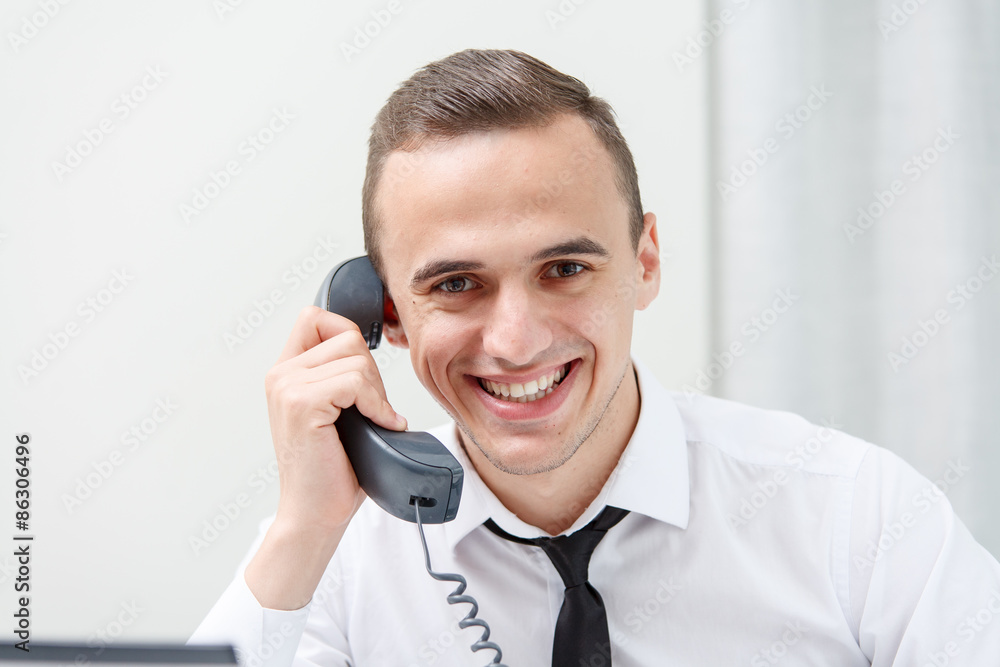 Angry businessman while communicating on phone in office Angry businessman while communicating on phone in office