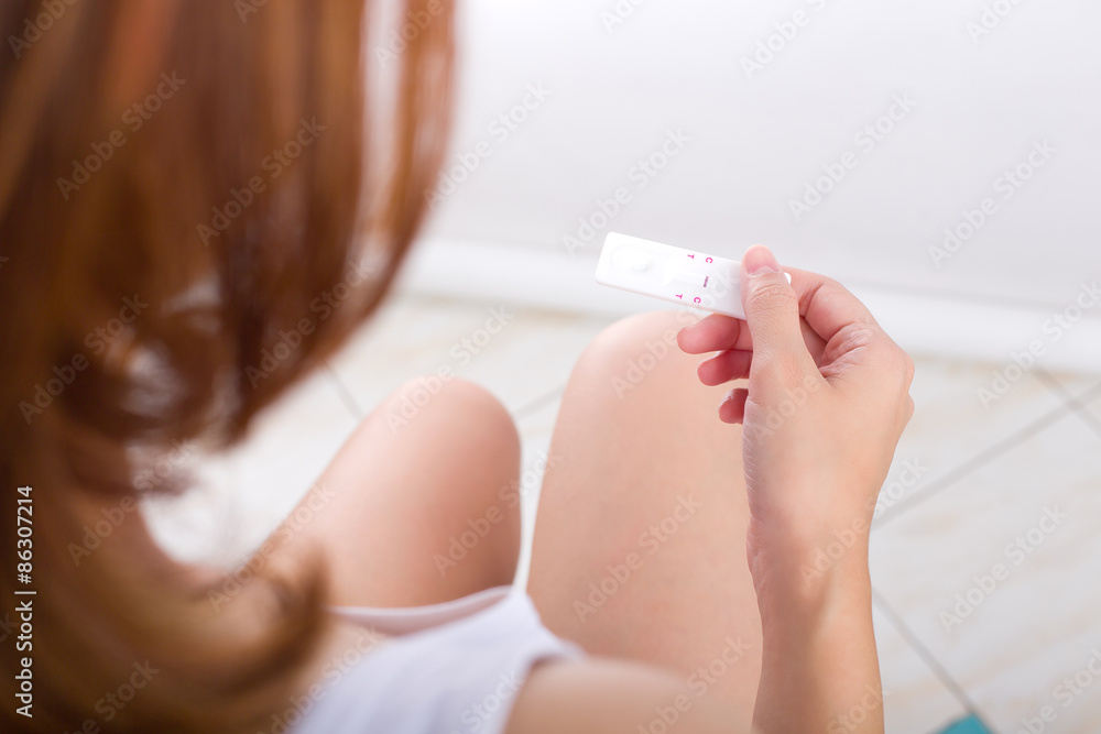 Young women checking pregnancy test. Young women checking pregnancy test.
