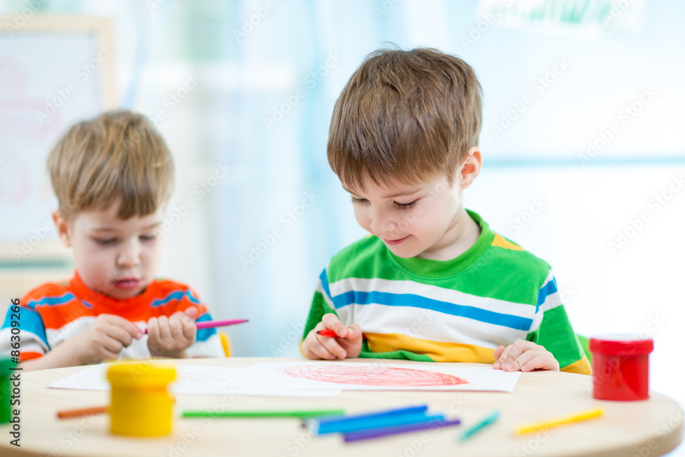 smiling children draw and paint at home or day care center smiling children draw and paint at home or day care center