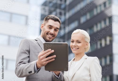 smiling businessmen with tablet pc outdoors