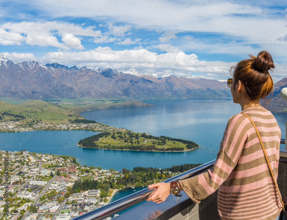 Fototapeta premium Young adult woman enjoy a stunning view of Queenstown