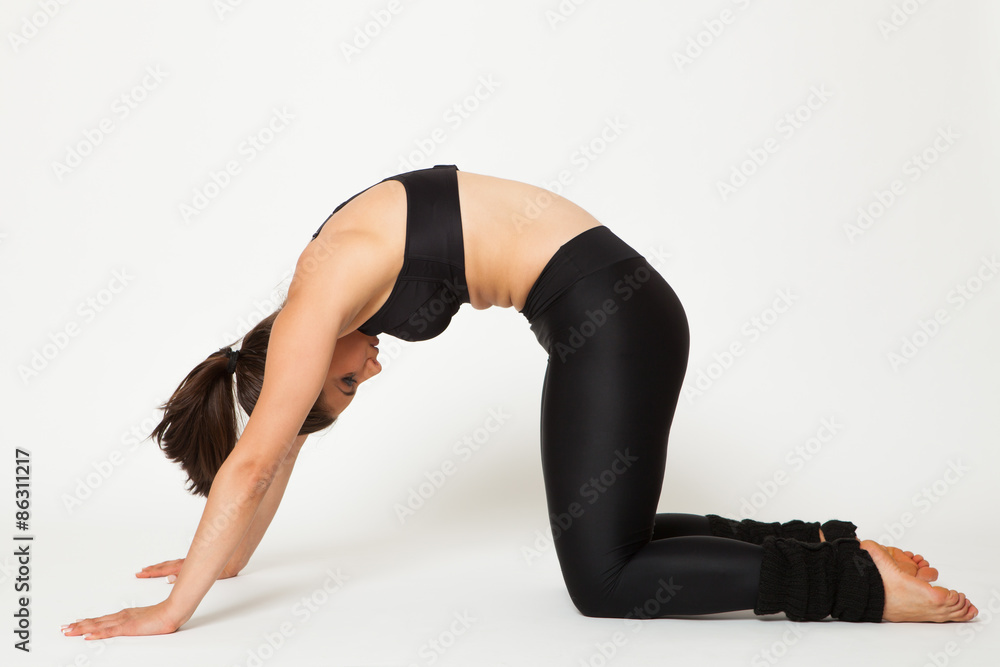 Sexy fit brunette woman in sportswear doing yoga exercise Studio shot. White background Sexy fit brunette woman in sportswear doing yoga exercise Studio shot. White background