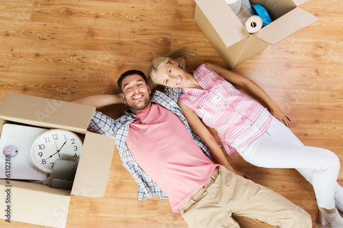 couple with big cardboard boxes moving to new home