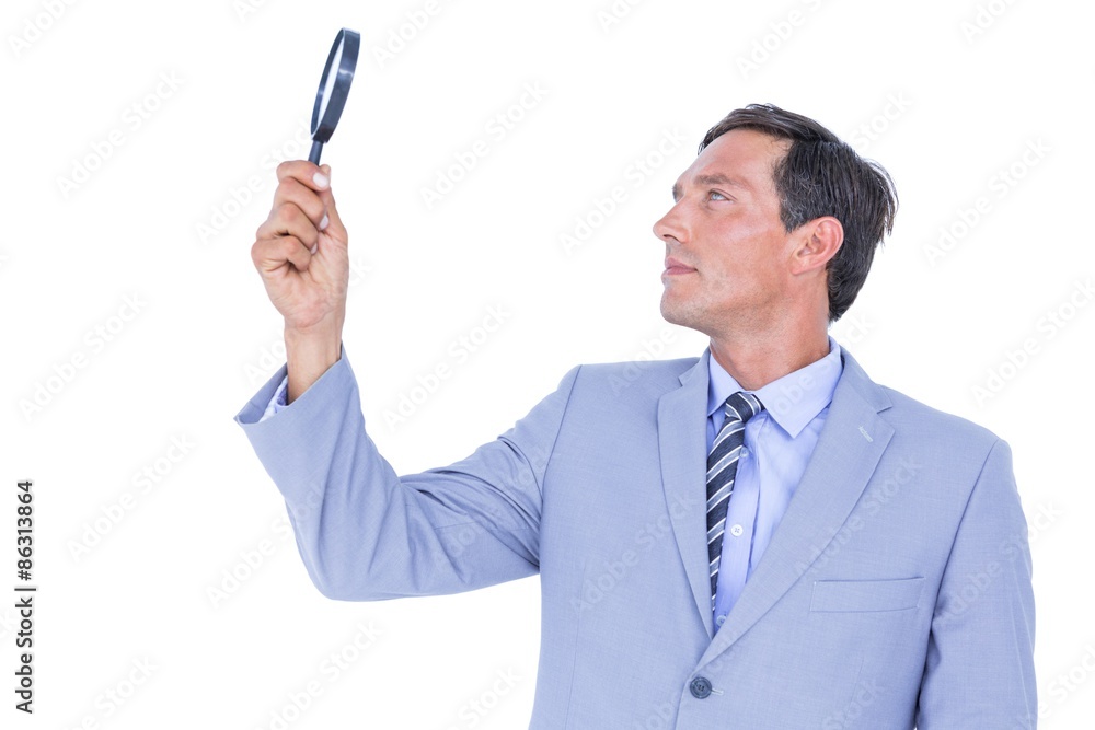 concentrated businessman using magnifying glass concentrated businessman using magnifying glass