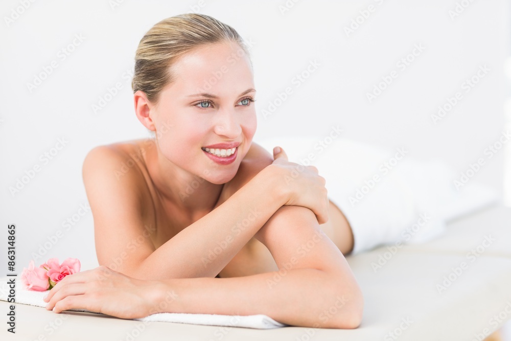 Peaceful blonde lying on towel smiling at camera Peaceful blonde lying on towel smiling at camera