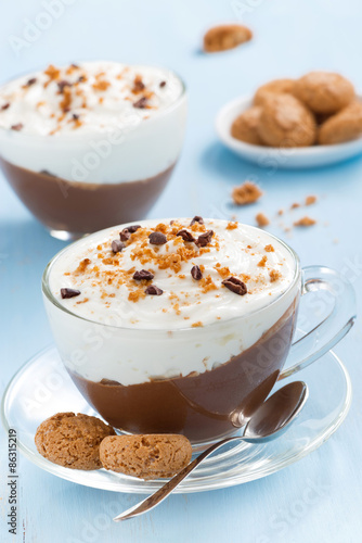 dessert with chocolate, cream and amaretti on a blue table