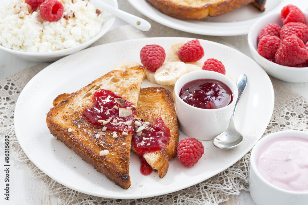 sweet breakfast - crispy toasts with raspberries, banana and jam sweet breakfast - crispy toasts with raspberries, banana and jam