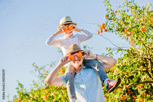 Happy father with his young son have fun on citrus farm 