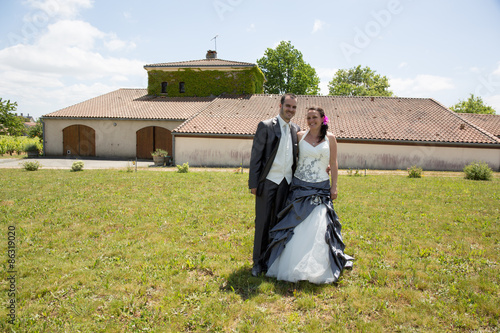 Newlywed couple in  after their wedding looking at the camera photo