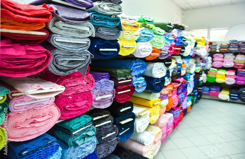Rolls of fabric and textiles in a factpory shop. © _jure