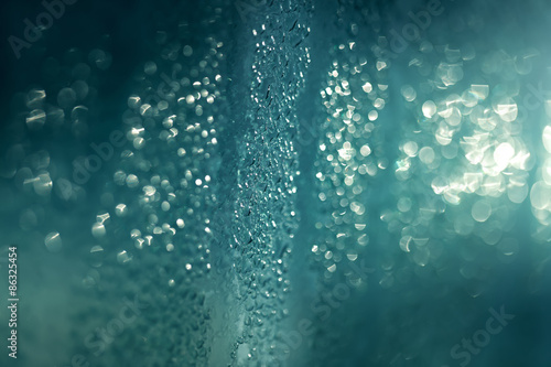 Rain drops background on glass in back light © rasica