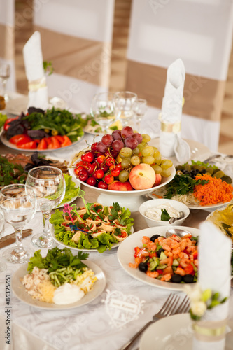 Festive table with fruit and snacks  salads