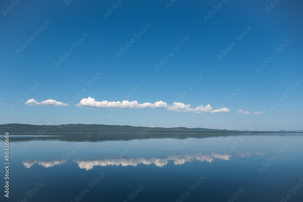 White cumulus clouds over the lake