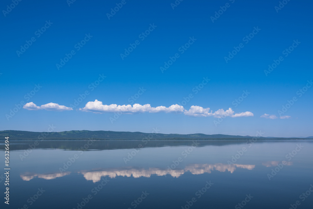 A beautiful panorama shot over a deep blue lake and sky