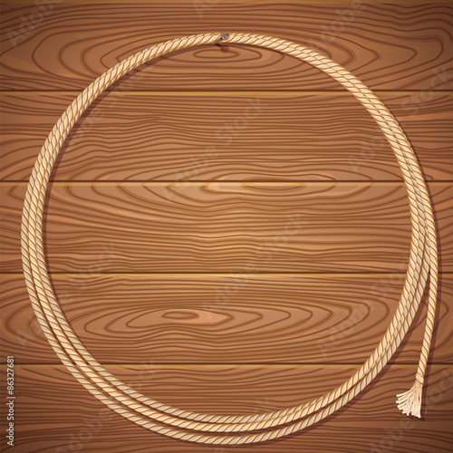 Rope lasso on wood background