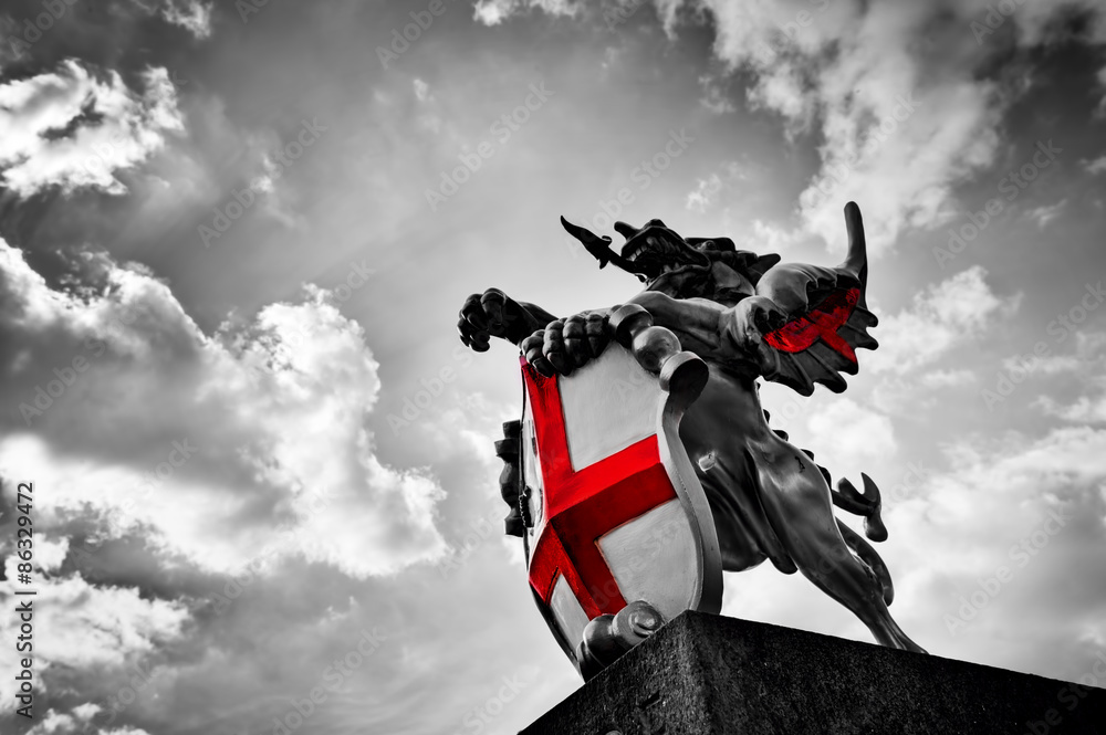 Fototapeta premium Posąg smoka św. Jerzego w Londynie w Wielkiej Brytanii. Czarno-biała, czerwona flaga, tarcza.