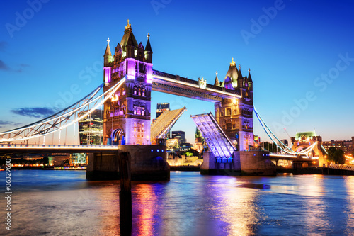 Tower Bridge in London, the UK. Night lights at late sunset.