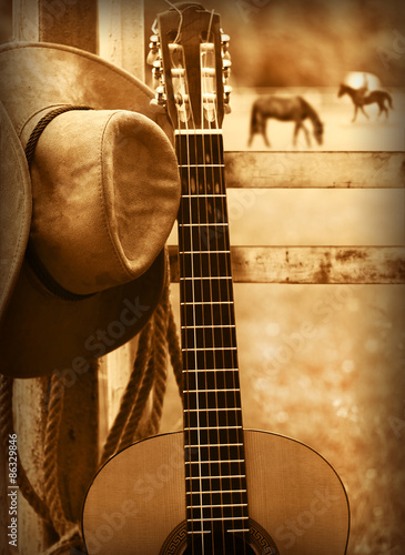 Cowboy hat and guitar.American music background photo