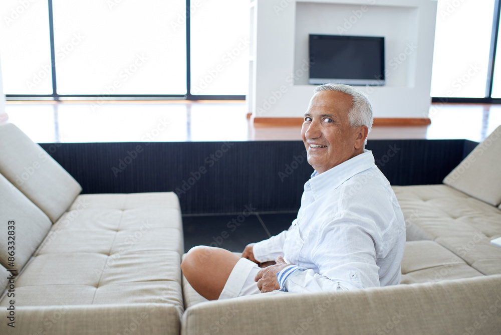 Portrait of senior man relaxing in sofa Portrait of senior man relaxing in sofa