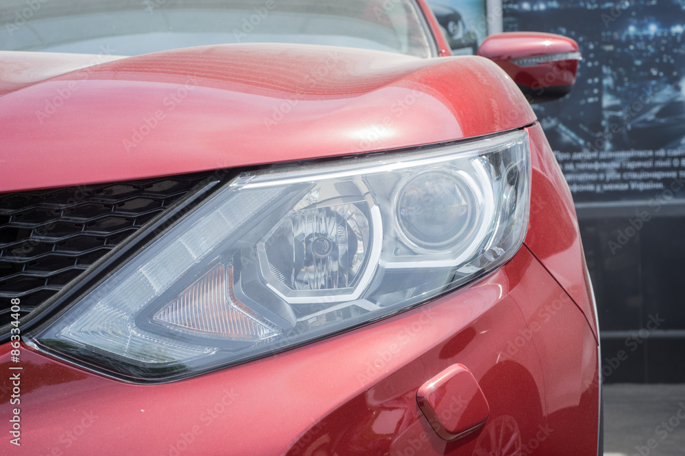 Elegant red car headlight outdoors