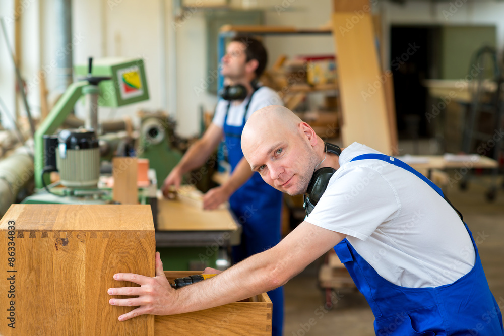 Obraz premium two worker in a carpenter's workshop