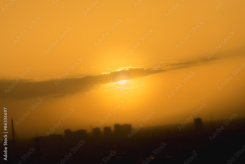 Orange sunset sky in urban with  mist