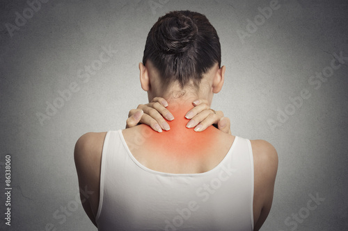 Fotografia Back spine disease. Closeup view tired female massaging her neck