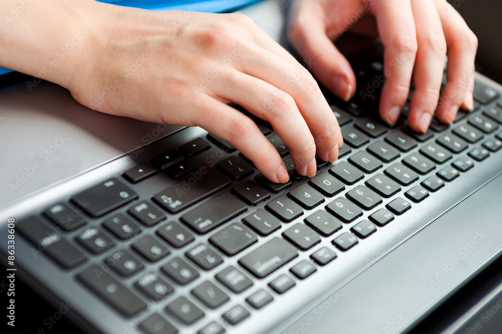 Unrecognizable businesswoman sitting in car with laptop computer on her knees. color image in horizontal orientation Unrecognizable businesswoman sitting in car with laptop computer on her knees. color image in horizontal orientation