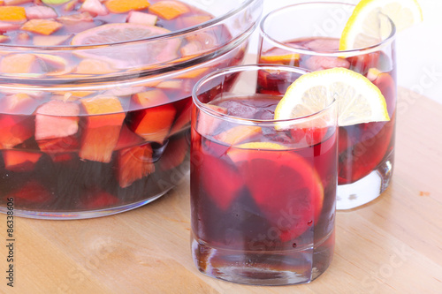 Sangria in glass bowl on wooden board