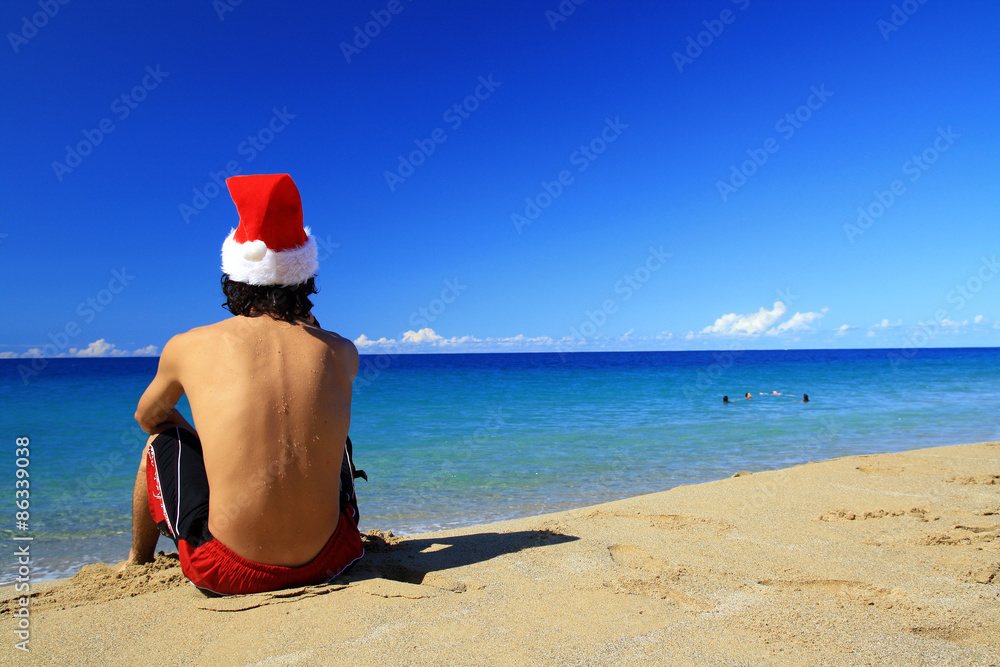Man in Santa hat on caribbean beach Man in Santa hat on caribbean beach
