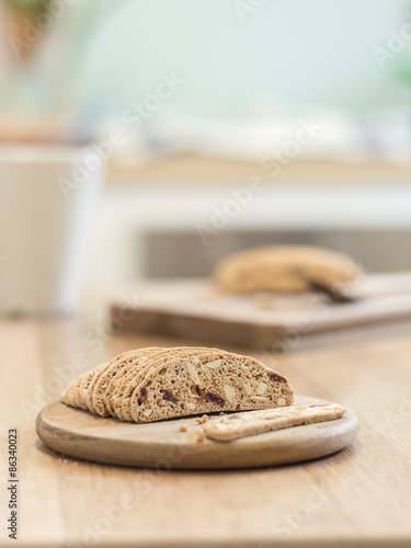 Slice almond biscuit cookie on wooden tray