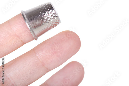 Metal thimble on finger