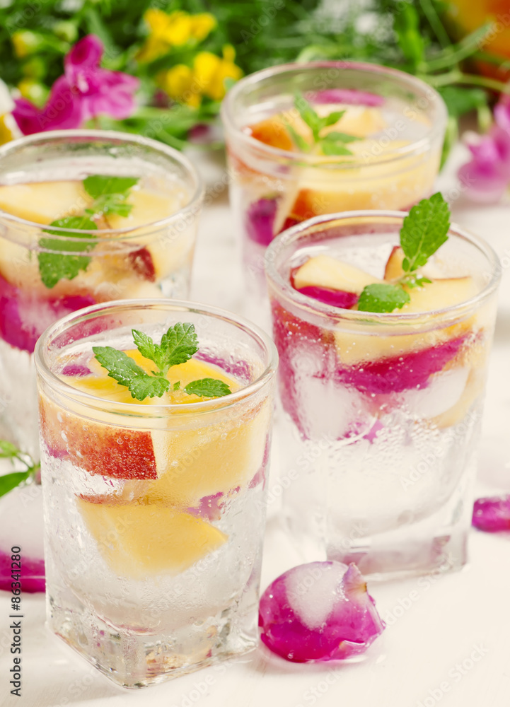 Fresh sparkling beverage with peaches and ice with rose petals o Fresh sparkling beverage with peaches and ice with rose petals o