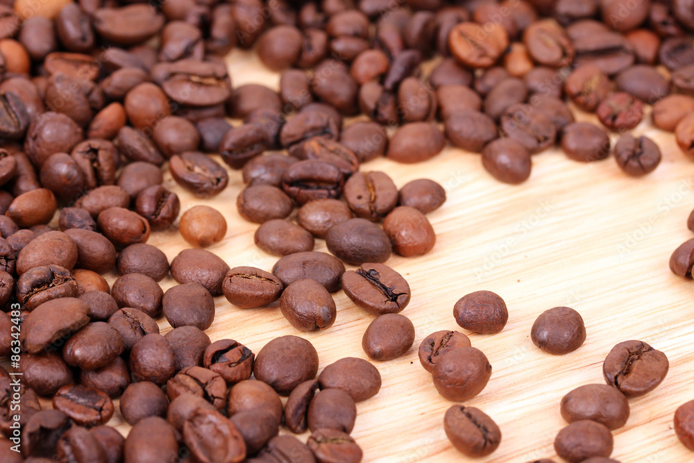 Coffee beans on wooden board Coffee beans on wooden board