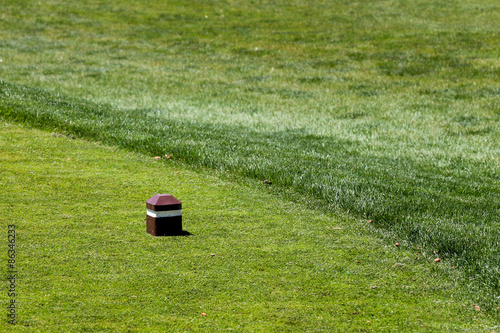 White striped tee box marker - women's teeing grounds at a golf course