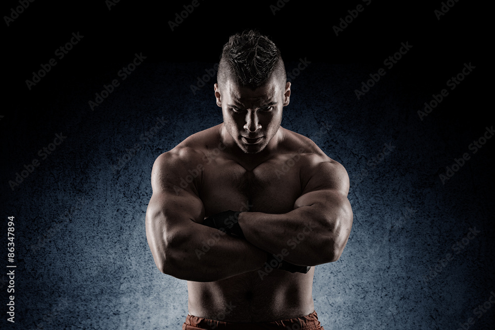young muscular guy in the studio, posing for the camera