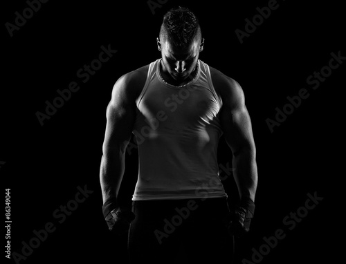 handsome young man after a workout on a dark background © romanolebedev