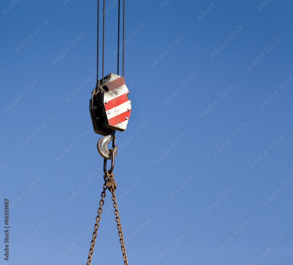 Crane hook against blue sky