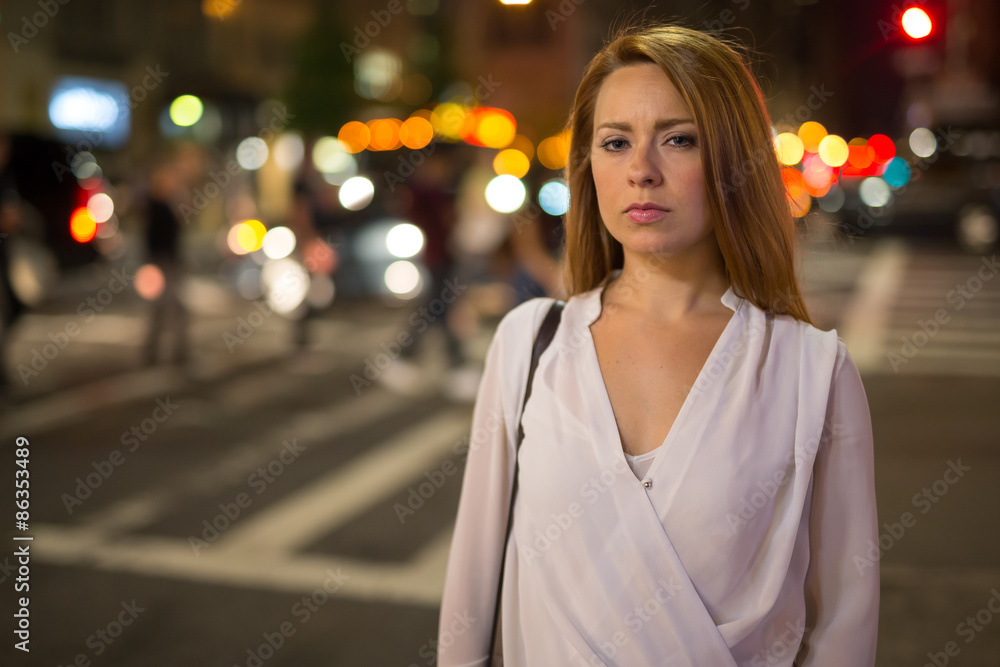 Young caucasian woman in city serious face at night Young caucasian woman in city serious face at night