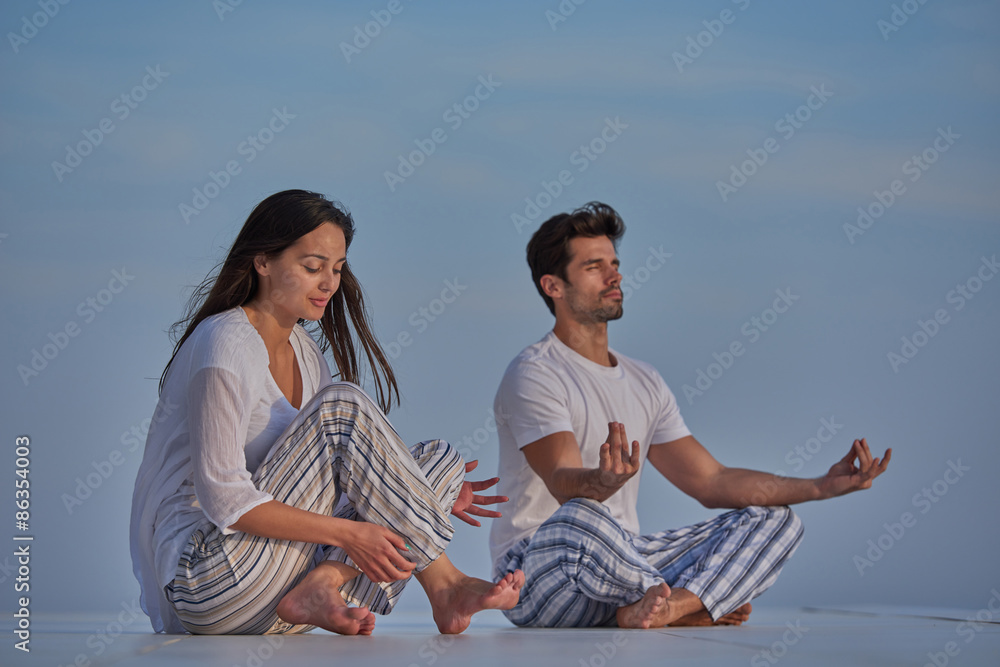 young couple practicing yoga